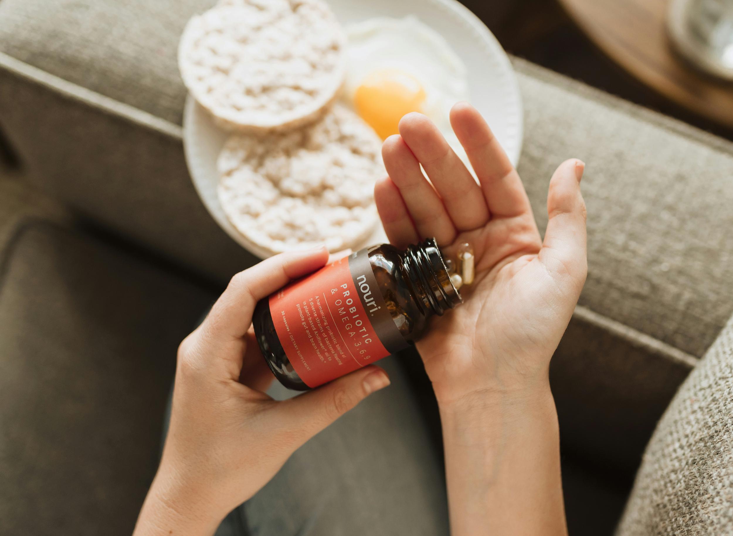 Selection of probiotic supplement capsules alongside natural probiotic foods like yoghurt and kefir