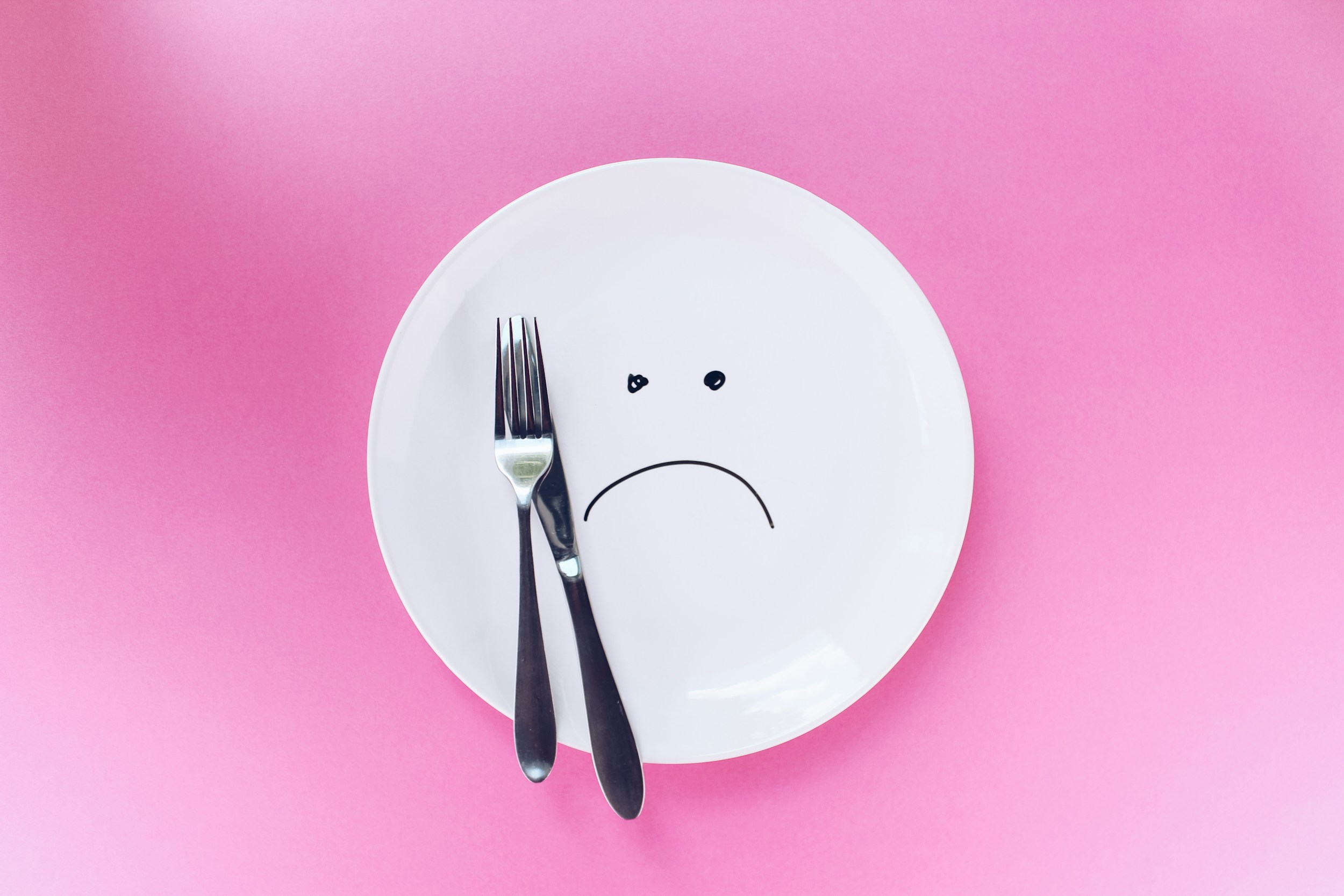 Person holding their stomach after a meal, looking uncomfortable from slow digestion