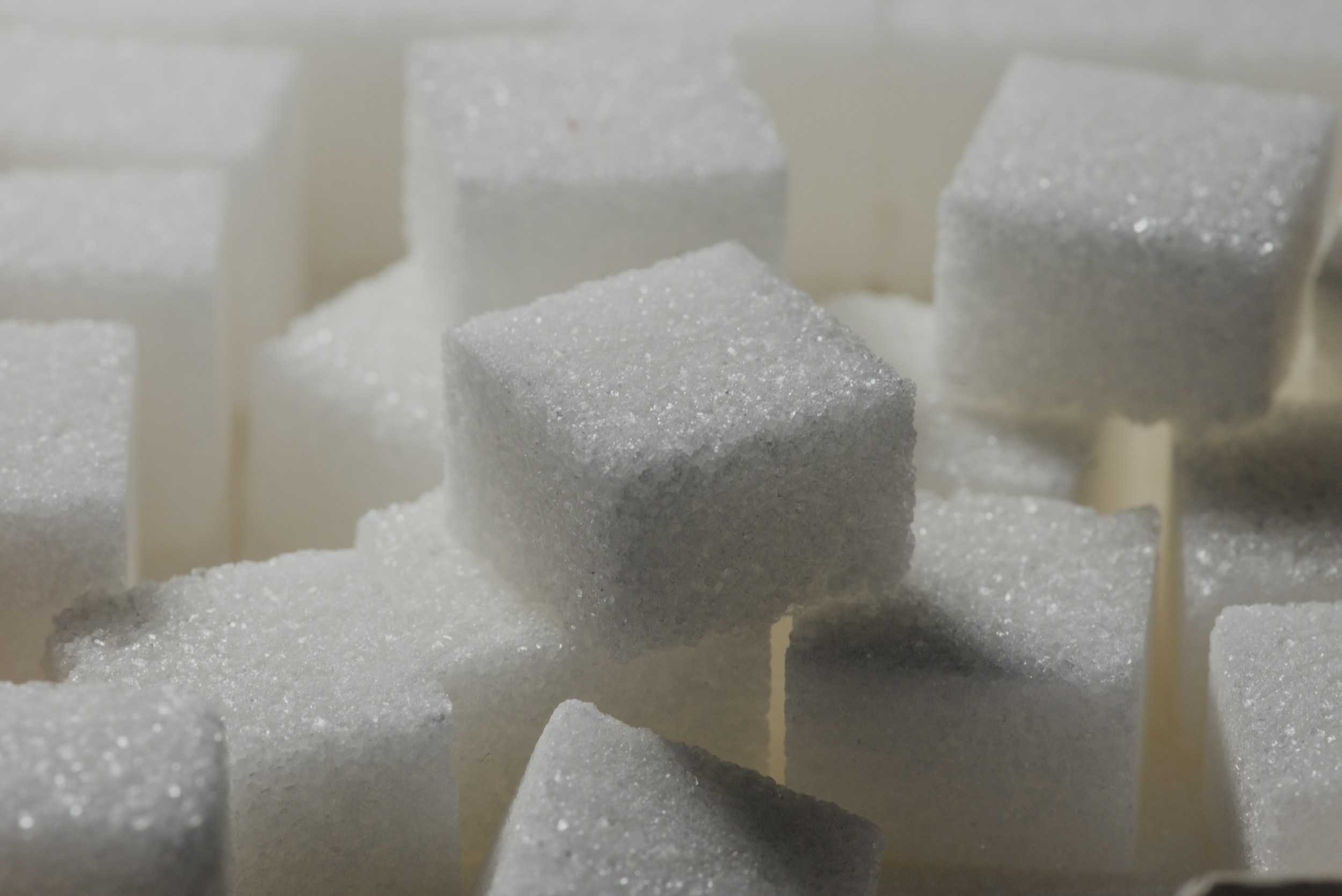 Assorted sugary foods next to healthy whole foods showing contrast for gut health